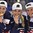 PLYMOUTH, MICHIGAN - APRIL 6: Team U.S.A.'s Megan Bozek #9, Emily Pfalzer #8, and Kelli Stack #16 bite their gold medals following a 3-2 overtime win against team Canada during the gold medal game at the 2017 IIHF Ice Hockey Women's World Championship. (Photo by Minas Panagiotakis/HHOF-IIHF Images)